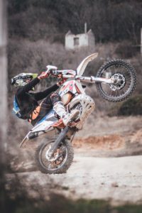 man riding motocross dirt bike