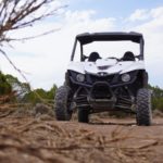 black and gray utv on brown ground